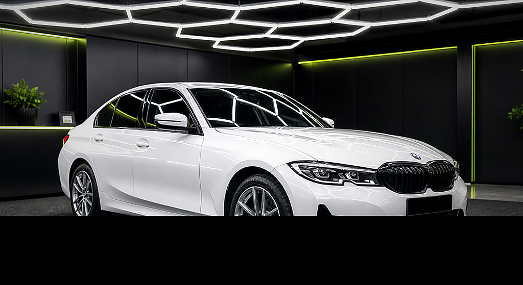 BMW 320i white side angle rental car